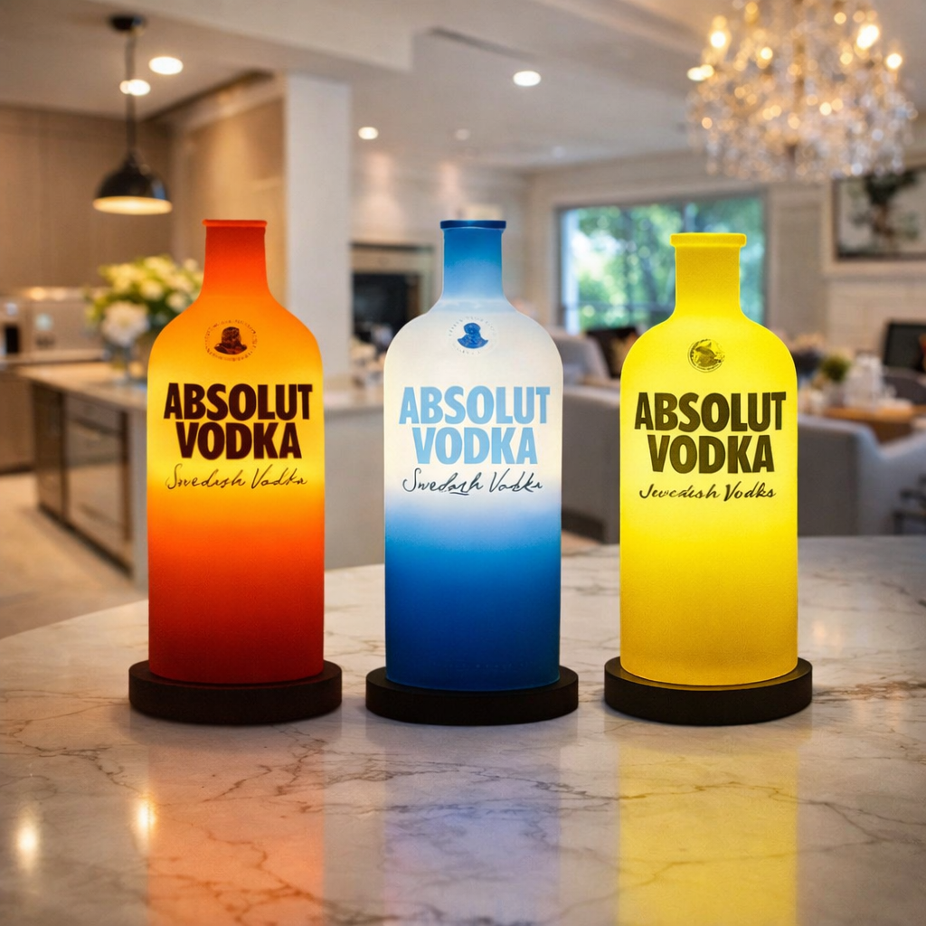 Set of three illuminated Absolut Vodka-themed lamps by Kavi The Poetry-Art Project displayed on marble surface.